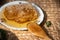 Fresh organic honeycomb with wooden spoon on wooden table at home