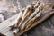 Fresh organic horseradish or Horse-radish root on wooden cutting board