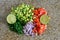 Fresh organic ingredients chopped for salsa, avocado, tomato, lime. on granite kitchen counter.