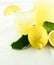 Fresh organic lemonade in a jar with lemons and leaves and a glass of lemonade