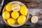 Fresh organic lemons in a colander on a wooden background. Top view