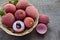 Fresh organic lychee fruits on a rustic wooden background.Exotic tropical litchi berry. Litchee.Raw diet or vegan food concept wit