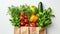 Fresh organic produce in a recyclable paper bag on a white background, concept of sustainable grocery shopping