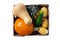 Fresh, organic pumpkin, acorn squash, butternut squash, zucchini, and potatoes in a wooden box close up, top view, isolated on wh