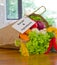 Fresh Organic Raw Vegetables food delivery in paper bag on wooden bench