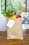 Fresh Organic Raw Vegetables food delivery in paper bag on wooden bench