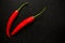 Fresh organic red chili on black background