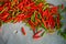 Fresh organic red and green color hot chillies on grey table background with copy space selling in local market for spicy food