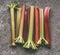 Fresh organic rhubarb stalks on gray granite table , top view. Healthy food
