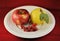 Fresh organic ripe fruits apple quince berries natural gourmet product white plate red background