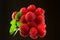 Fresh organic ripe raspberries on black background