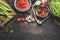 Fresh organic seasonal vegetables on dark rustic wooden background. Tomatoes , Green french beans and cooking ingredients for tas