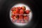 Fresh organic strawberries in a plastic box on a white background in a dark stroke. delivery of organic products. packaging of