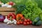 Fresh organic vegetables in a wooden box and on a wooden table on the background of a vegetable garden.Concept of biological, bio