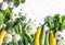 Fresh organic vegetables - zucchini, squash, cucumbers, broccoli, onions, garlic, chard, green peas on a light background with cop
