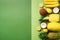 Fresh organic yellow fruits over green background. Monochrome concept with banana, coconut, pineapple, lemon, melon. Top