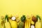 Fresh organic yellow fruits over sunny background. Monochrome concept with banana, coconut, pineapple, lemon, melon. Top