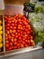 Fresh organic young tomato sold on market. Tomato on market.New harvest of sweet ripe raw tomato fruit on market close up