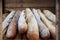 Fresh oven baguette in a wooden box