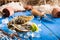 Fresh oyster on ice on a blue wooden table