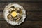Fresh oyster on plate on a brown wooden table