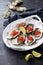 Fresh oysters, garnished with red caviar and lime. Served on a white platter