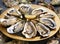 Fresh oysters on a golden plate with lemon