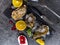 Fresh oysters in ice with lemon, cranberries, glass for wine or champagne, knife over stone table, top view