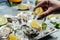 Fresh oysters on ice with lemon. Healthy food, gourmet food. Oyster dinner in restaurant