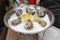 Fresh oysters and lemon on ice in plate close-up. Gastronomic gourmet dainty products on market counter, real scene