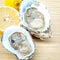 Fresh Oysters with lemon on wooden background. Opened Oysters w