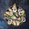 Fresh oysters with lime on round plate. Several varieties of oysters.Oyster on half shell