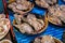 Fresh oysters for sale in containers at an Asian wet market and supermarket.