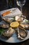 Fresh oysters white plate and lemon on wooden desk