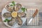 Fresh oysters white plate and lemon on wooden desk