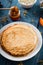 Fresh pancakes with honey, maple syrup, cottage cheese and tangerines. Wooden background. Top view