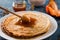 Fresh pancakes with honey, maple syrup, cottage cheese and tangerines. Wooden background. Top view