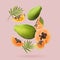Fresh papaya fruits and green leaves falling on dusty pink background