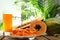 Fresh papayas and juice on wooden table against blurred background