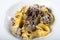 Fresh pappardelle pasta with porcini mushrooms and truffle scent. Parmesan and mozzarella cheese