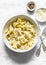 Fresh pappardelle with walnuts mascarpone cheese cream sauce. Delicious lunch in mediterranean style on a light background, top