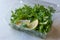 Fresh Parsley and Arugula / Rucola Leaves with Lemon in Plastic Container.