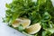 Fresh Parsley and Arugula / Rucola Leaves with Lemon in Plastic Container.