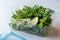 Fresh Parsley and Arugula / Rucola Leaves with Lemon in Plastic Container.