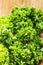 Fresh parsley on wooden surface, freshly picked curly parsley from the garden on the old wooden table