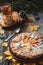 Fresh pastry apple pie with sugar powder on wooden table with hot drink tea and cinnamon on background. Homemade cake Thanksgiving