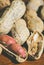 Fresh peanuts in shel and peeled without shell on the wooden table background close up