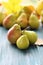 Fresh pears, autumn leaves on a wooden table, organic fruits