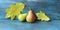 Fresh pears, autumn leaves on a wooden table, organic fruits