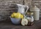 Fresh pears in bowl, cinnamon, sugar and vintage crockery on a dark wooden background. Kitchen still life